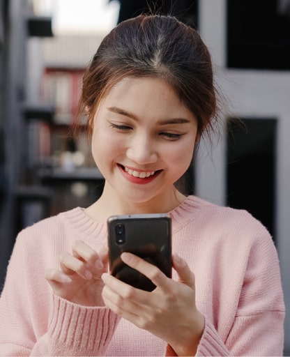 cheerful-asian-woman-using-smartphone